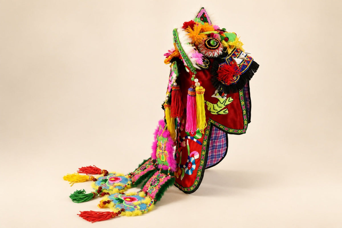 Studio product photograph of a tiger hat with embroidered ribbons
